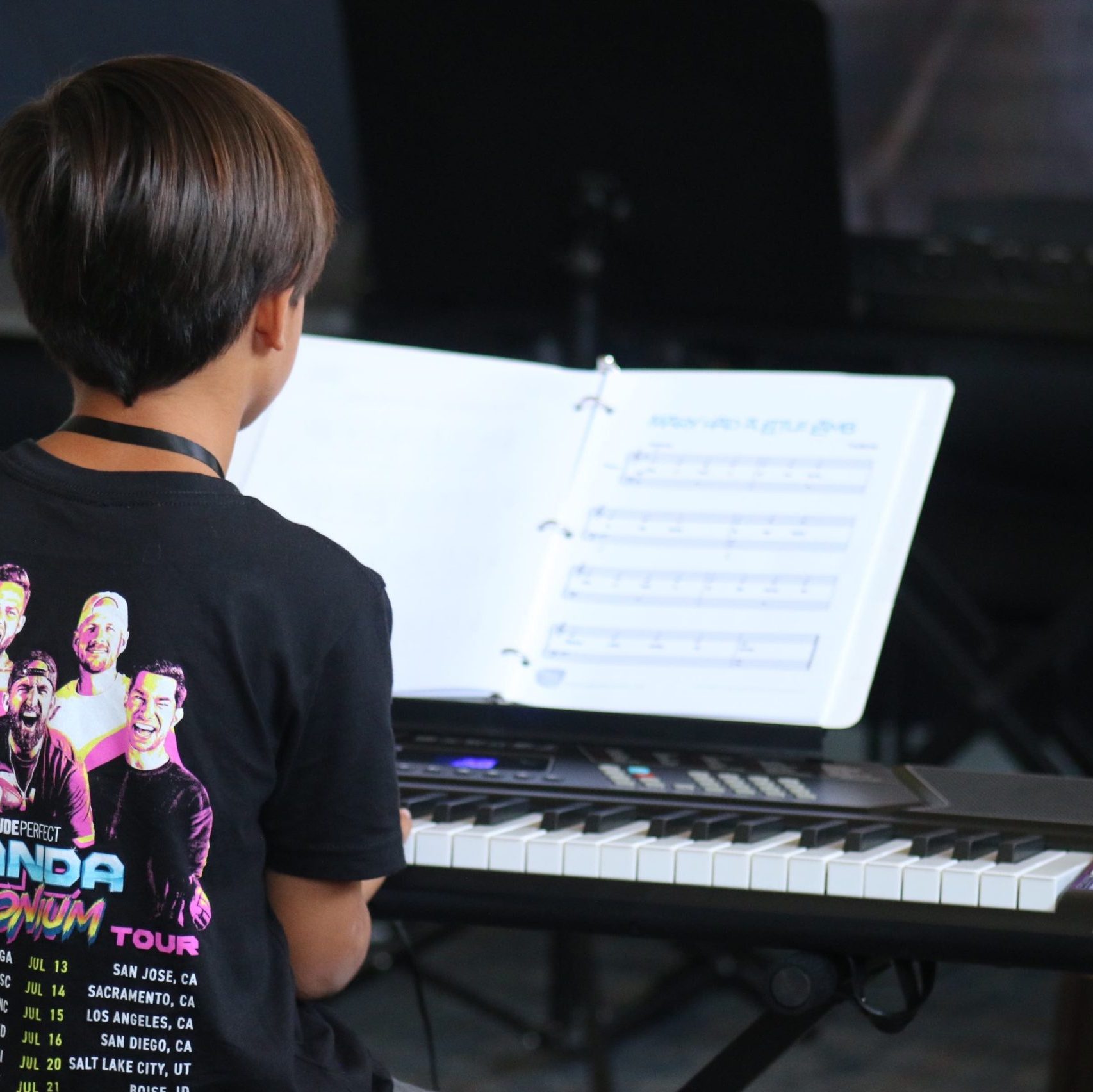 A kid learning how to play Piano